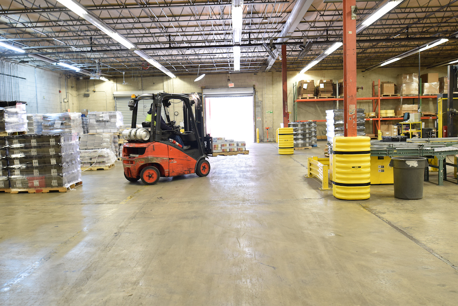 forklift moving pallet in warehouse
